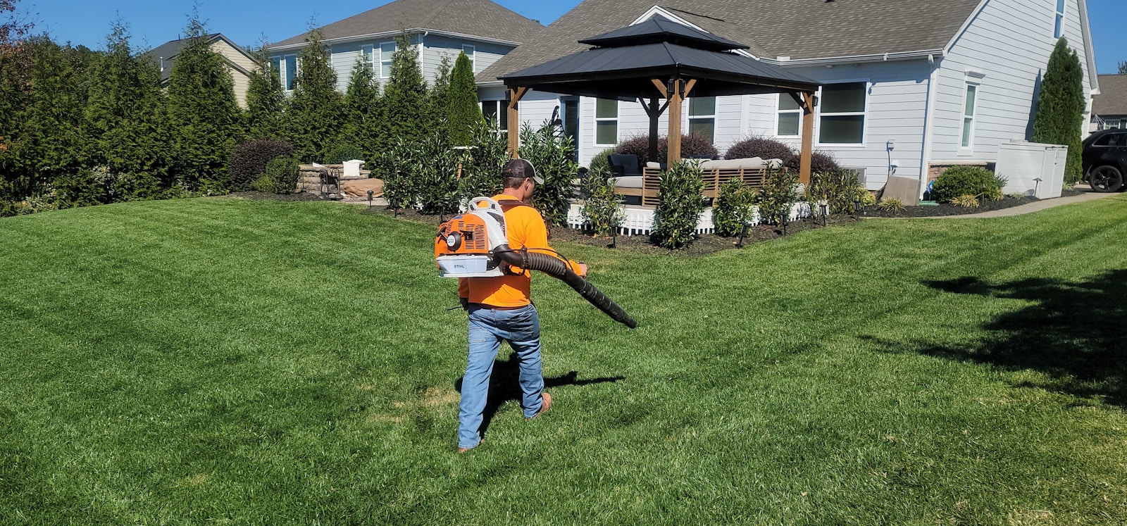 Photo by Michael Smith A man in an orange shirt holding a baseball bat